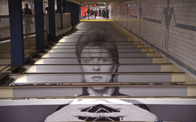 A David Bowie art installation is seen at the Broadway-Lafayette subway station on April 19, 2018 in New York City. - The subway-wall-sized images of Bowie-inspired art, is in collaboration with Spotify and the Brooklyn Museum's current exhibition "David Bowie Is."